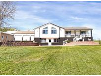 Charming two-story home features well-manicured lawn and beautiful brick accents, offering delightful curb appeal at 18553 County Road 5, Berthoud, CO 80513