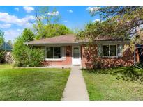Charming brick home with a well-maintained lawn and inviting front entrance at 5455 Dudley Ct, Arvada, CO 80002