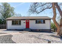 Charming single-story home featuring a red door and low maintenance landscaping with gravel and rock at 8540 Corona St, Denver, CO 80229