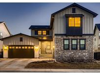 Beautiful two-story home with stone and siding exterior, attached garage, and inviting front entrance at 9245 Star Streak Cir, Littleton, CO 80125