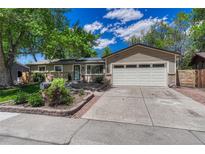 Charming single-story home with a large front yard, attached garage, and appealing curb appeal at 4539 E Caley Pl, Centennial, CO 80121