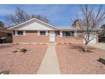 Charming brick home featuring a well-manicured yard and a cozy, inviting entryway at 1008 Yeager Dr, Longmont, CO 80501
