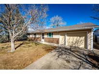 Charming single-story home with attached garage, brick accents, and mature trees in a residential neighborhood at 750 4Th St, Bennett, CO 80102