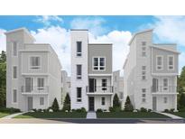 Contemporary townhome with multi-textured facade, balcony, and landscaped front yard at 1257 Rhett Dr, Erie, CO 80026