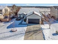 Beautiful single Gathering home featuring a driveway with a large garage and a well manicured lawn at 1180 Crenshaw St, Castle Rock, CO 80104