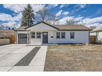 Charming single-story home with a well-maintained lawn, driveway, and a one car garage at 1531 S Lowell Blvd, Denver, CO 80219
