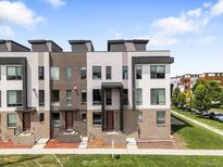 Modern townhomes with brick and siding, offering a stylish and contemporary facade at 3103 W 18Th Ave, Denver, CO 80204