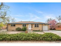 Charming brick home featuring an attached garage, landscaped front yard, and a beautifully maintained lawn at 6625 S Ogden St, Centennial, CO 80121