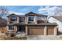 Charming two-story home with a three car garage and manicured lawn and brick accents on the front at 13297 Humboldt Dr, Thornton, CO 80241