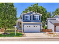 Charming two-story home with a well-maintained lawn, classic siding, and a two car garage in a suburban neighborhood at 1201 Trout Creek Cir, Longmont, CO 80504