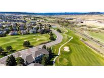 Stunning aerial view of a residential neighborhood with a golf course and mountain views at 3383 Mount Royal Dr # 46, Castle Rock, CO 80104