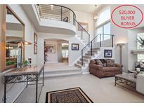 Grand entryway boasts a curved staircase, high ceilings, and $20,000 buyer bonus offer at 9531 Desert Willow Way, Highlands Ranch, CO 80129