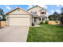 Charming two-story home with a manicured lawn and a two-car garage in a desirable neighborhood at 11100 Callaway Ct, Parker, CO 80138