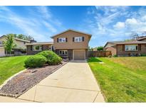 Inviting two-story home featuring neutral siding, brick accents, and a well-manicured front yard at 9225 Lowell Blvd, Westminster, CO 80031