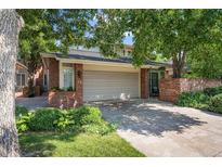 Charming single-Gathering home showcasing a well-manicured lawn, mature trees, and a convenient two-car garage at 2552 E Alameda Ave # 74, Denver, CO 80209