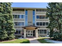 Inviting condominium with well-maintained landscaping and covered entrance in a serene residential area at 9180 E Center Ave # 9D, Denver, CO 80247
