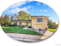 Charming two-story home with a well-manicured lawn and beautiful landscaping at 7162 S Fillmore Cir, Centennial, CO 80122