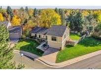 Inviting two-story home with well-manicured lawn and beautiful fall foliage at 7162 S Fillmore Cir, Centennial, CO 80122