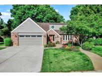 Charming home featuring a well-manicured front yard and an attached two-car garage at 56 Spyglass Dr, Littleton, CO 80123