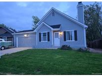 Charming two-story home featuring a well-maintained lawn and a classic architectural style at 17605 E Temple Dr, Aurora, CO 80015