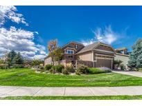 Beautiful two-story home with landscaped lawn and attached garage at 22178 E Stroll Ave, Parker, CO 80138