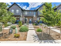 Modern townhomes feature a stylish exterior with stone accents and well-maintained landscaping at 6350 N Lisbon St, Aurora, CO 80019