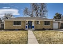 Charming single-story brick home with a well-maintained lawn and inviting front entrance at 6500 W 32Nd Ave, Wheat Ridge, CO 80033