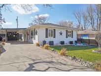 Charming single-story home featuring a covered carport and well-maintained front yard at 1325 S Clermont St, Denver, CO 80222