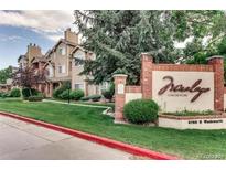 Charming condominium community with lush landscaping, a welcoming sign, and well-maintained exteriors at 4760 S Wadsworth Blvd # G304, Littleton, CO 80123