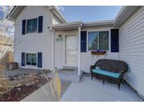 Charming two-story home featuring a covered front porch and vibrant blue shutters at 4922 S Salida Ct, Aurora, CO 80015