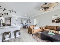 Bright living room features modern furnishings, sleek ceiling fan and light gray walls at 2151 Enterprise St, Superior, CO 80027
