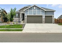 Charming two-story home featuring a three-car garage and stone accents at 5417 Riverbend Ave, Firestone, CO 80504