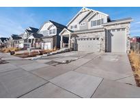 Charming two-story home boasts a stone facade and a spacious three-car garage at 21901 E 42Nd Place, Aurora, CO 80019