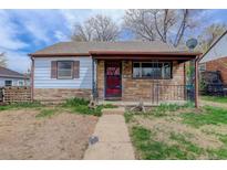 A charming home featuring a stone and white facade, complete with a covered front porch and garden area at 1270 Elmira St, Aurora, CO 80010