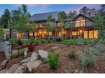 Home's exterior showcasing professionally landscaped yard and stylish balconies at 1298 Meadow View Dr, Evergreen, CO 80439