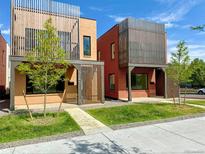 Modern brick homes with unique wooden slat accents and well-manicured front lawns create appealing curb appeal at 3285 Lawrence St, Denver, CO 80205