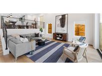 Spacious living room featuring an accent rug, modern furnishings, and abundant natural light at 3285 Lawrence St, Denver, CO 80205