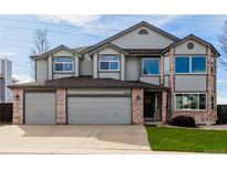 Charming two-story home with brick accents and a three-car garage at 9275 Erminedale Dr, Lone Tree, CO 80124