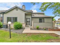 Charming townhome featuring a well-maintained lawn and stone accents at 9183 W Cedar Dr # 2, Lakewood, CO 80226