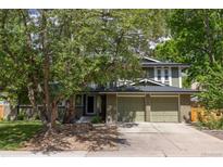 Charming exterior featuring a large front yard, and a two-car garage at 7150 S Curtice St, Littleton, CO 80120