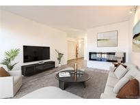 Bright living room features a fireplace and an open floor plan at 8470 Decatur St # 89, Westminster, CO 80031