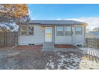 Cute ranch home with gray exterior, landscaping, and a fenced yard at 740 Fulton Ave, Fort Lupton, CO 80621