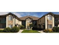 Attractive apartment complex featuring manicured landscaping, stone accents, and private balconies for comfortable outdoor living at 3271 E 103Rd Pl # 1309, Thornton, CO 80229