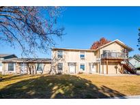 Charming exterior view of a two-story home with a well-maintained lawn on a sunny day at 2105 Coronado Pkwy # C, Denver, CO 80229