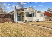 Cute ranch home with landscaped yard, charming front porch, and a welcoming entryway at 1660 S Cook St, Denver, CO 80210