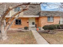 Charming brick townhome with a well-maintained front yard and inviting entrance at 13015 W Ohio Ave, Lakewood, CO 80228