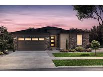 Charming single-story home featuring stone accents, a two-car garage, and a well-maintained front yard at 4125 N Duquesne Ct, Aurora, CO 80019