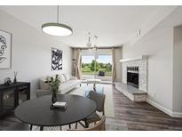 Bright living room featuring modern decor, fireplace, and a large window for natural light and scenic views at 4273 S Salida Way # 1, Aurora, CO 80013