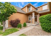 Charming home with a well-manicured lawn and inviting front porch, perfect for enjoying peaceful moments at 11705 W Stanford Ln, Morrison, CO 80465