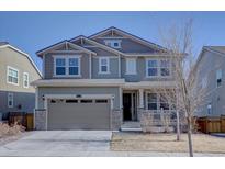 Two-story home boasts a neutral color scheme and attached two car garage at 8760 Ginkgo Loop, Parker, CO 80134